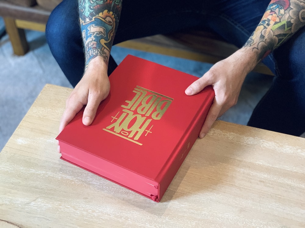 red book on brown wooden table