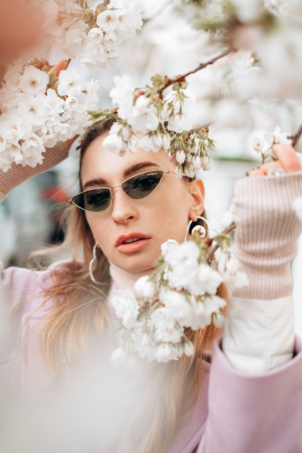 woman in white long sleeve shirt wearing sunglasses