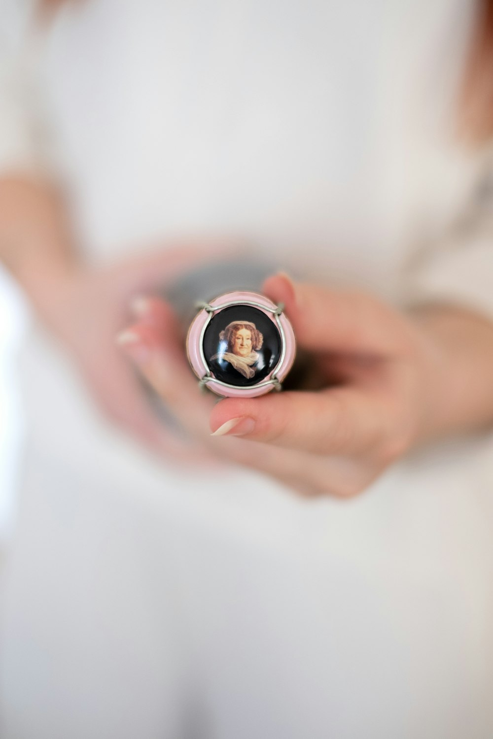 person holding silver and black ring