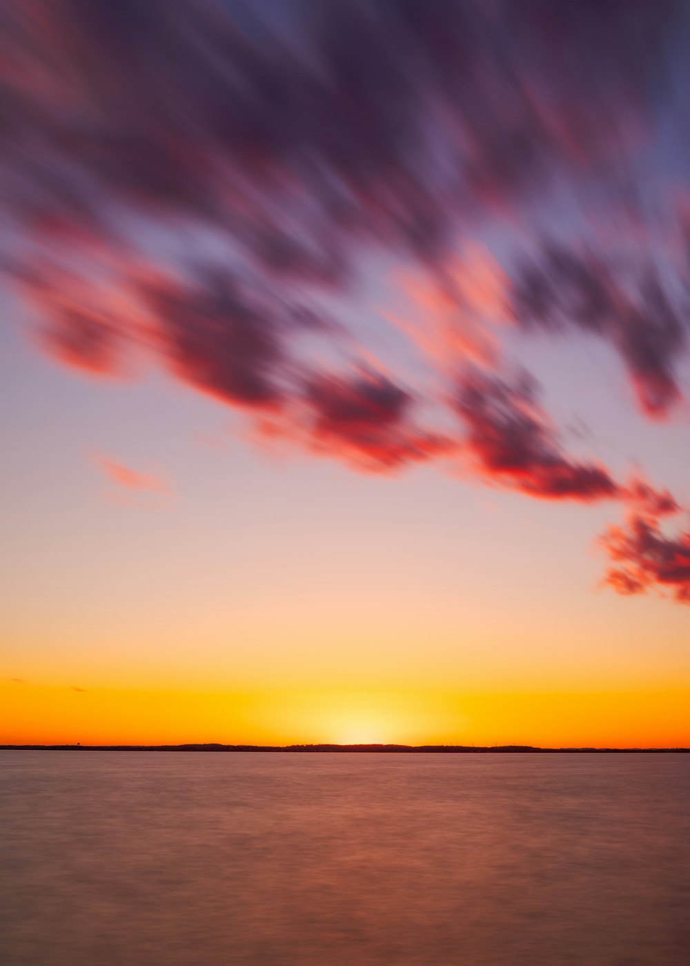 body of water during sunset