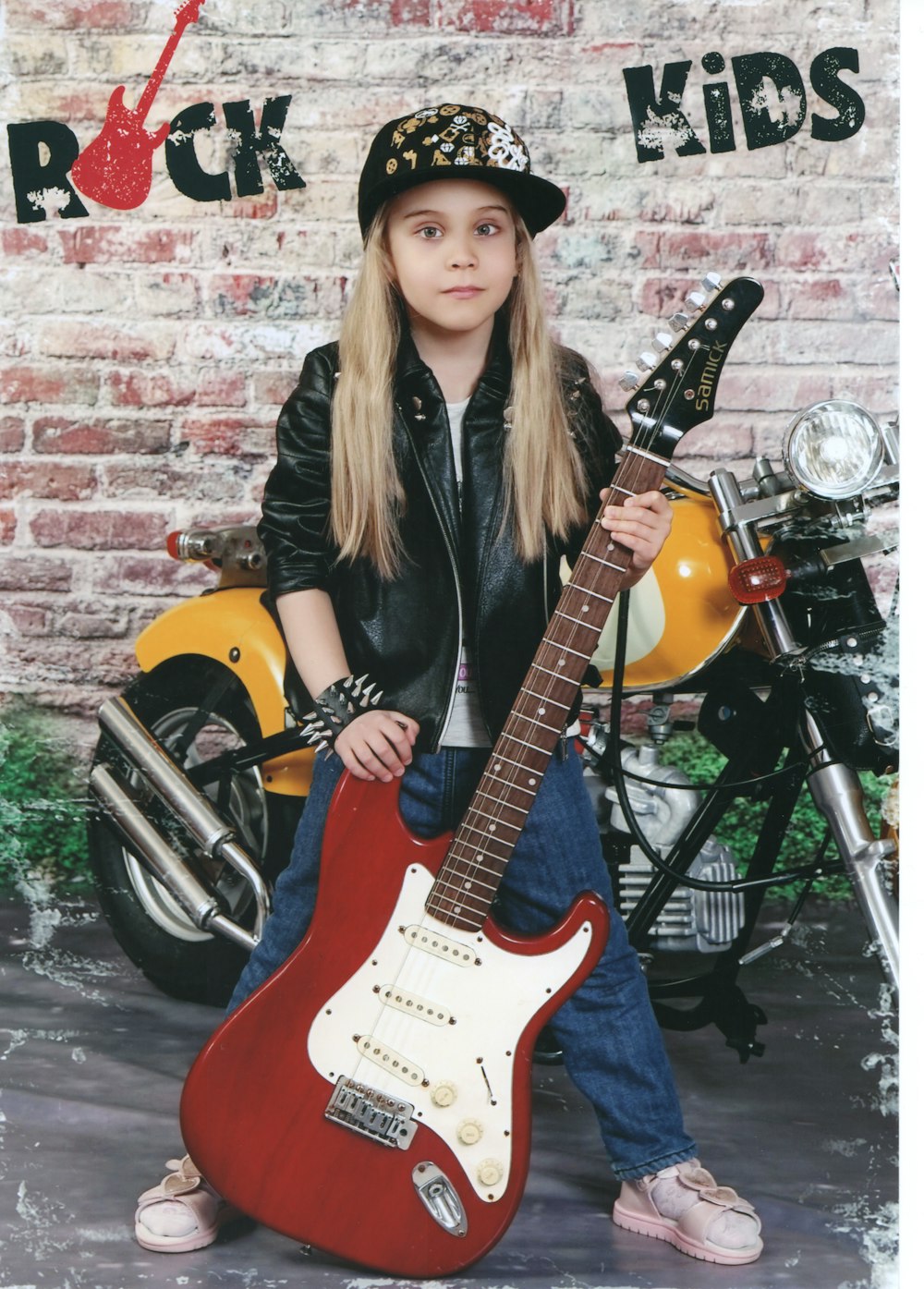 woman in black leather jacket holding yellow electric guitar