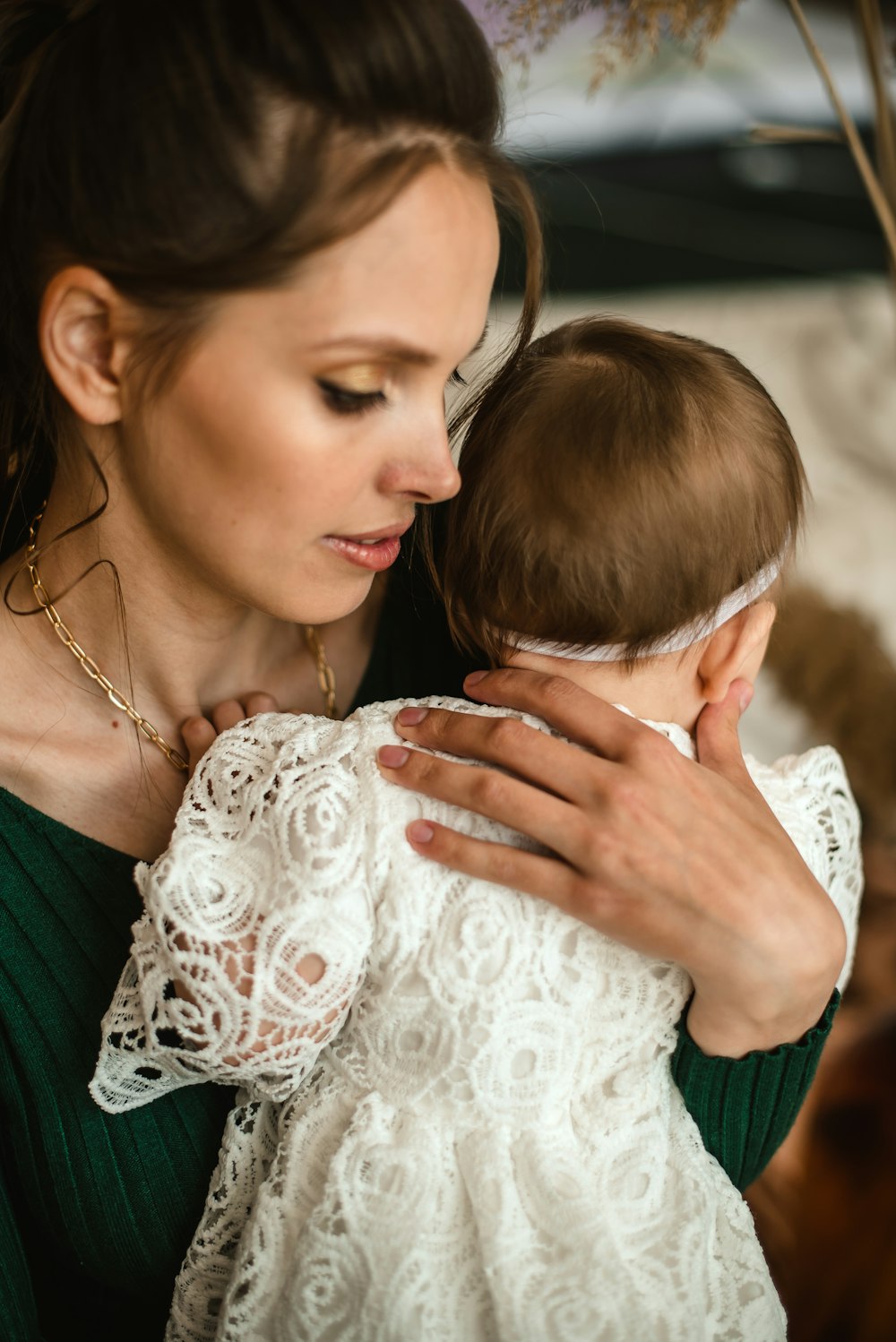 woman in white floral lace dress holding white floral textile