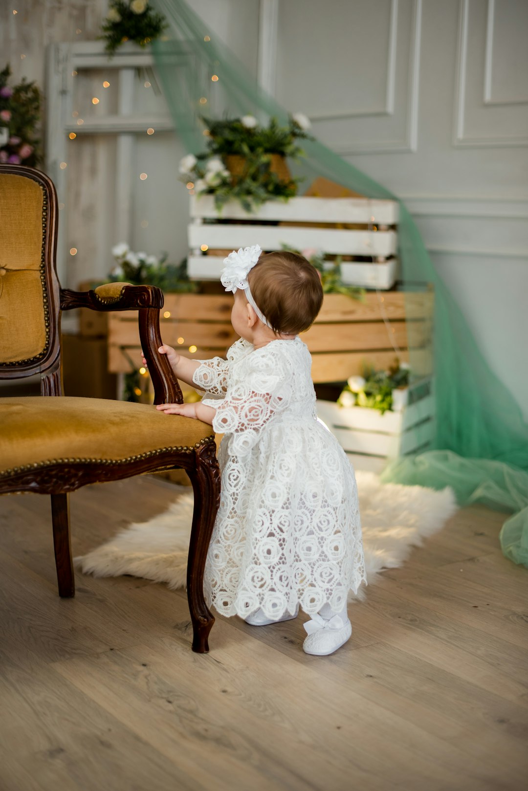 girl in white dress sitting on brown wooden chair