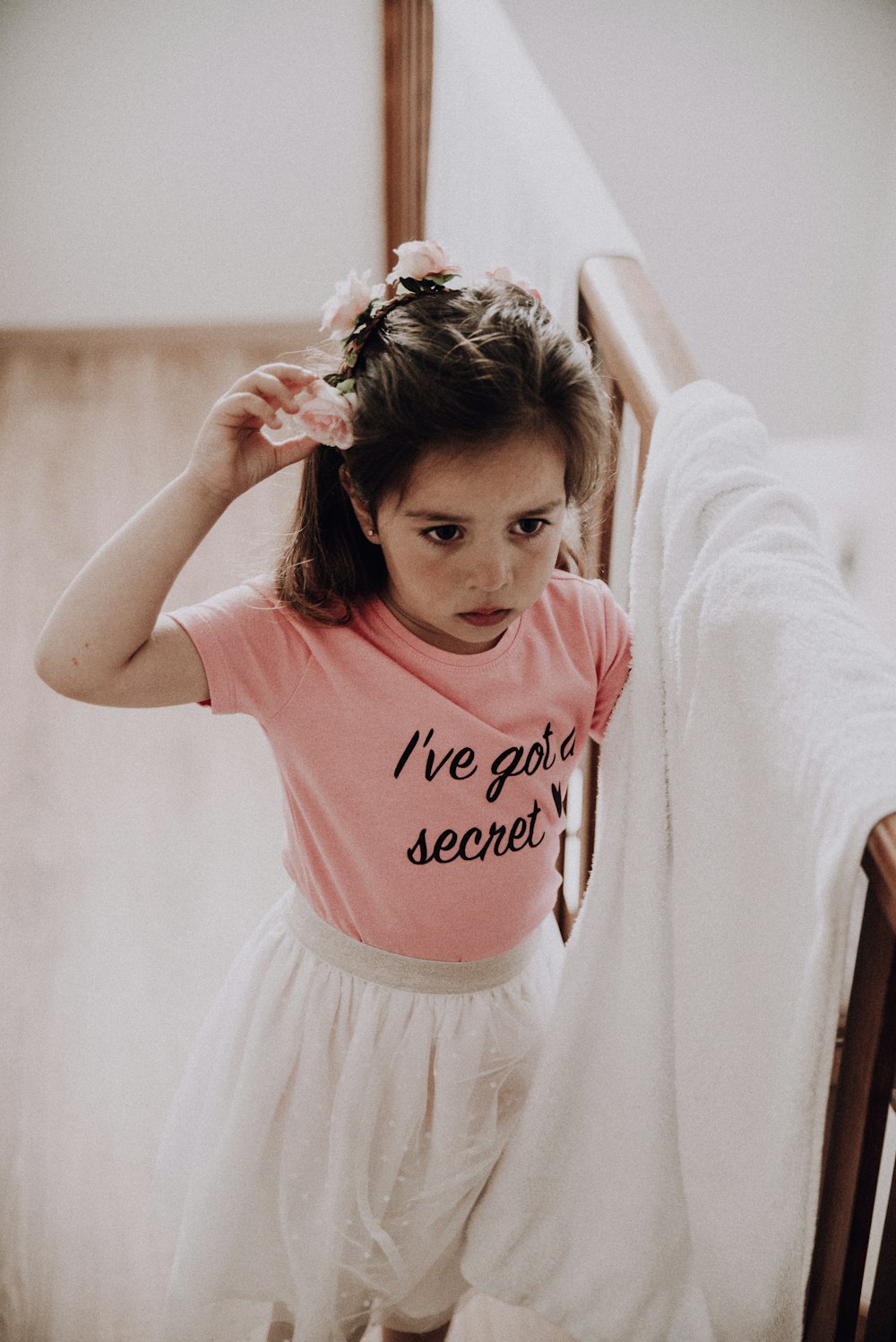 girl in pink and white crew neck t-shirt and white skirt