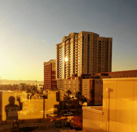 Modern Dubai skyline at sunset with corporate buildings reflecting golden light.