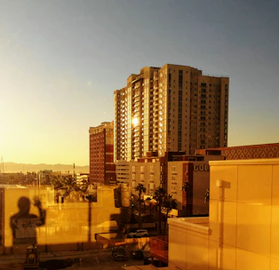 Modern Dubai skyline at sunset with corporate buildings reflecting golden light.