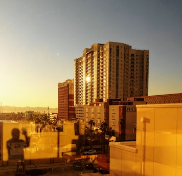 Elegant luxury Miami skyline at sunset with golden hues reflecting on high-rise condos.