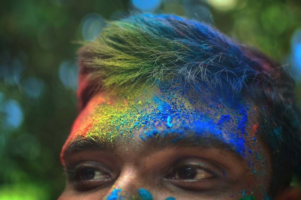 person with blue and red powder on face