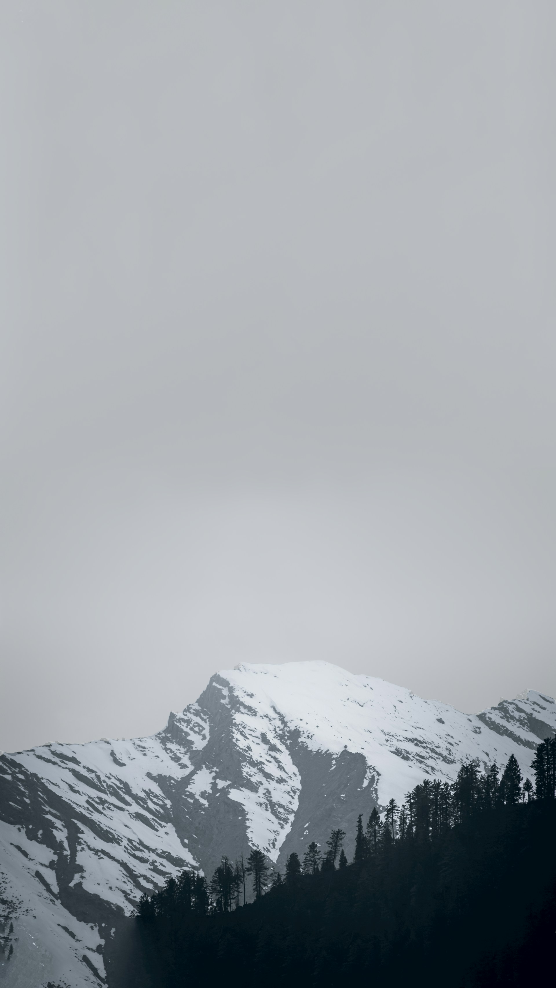 snow covered mountain under white sky