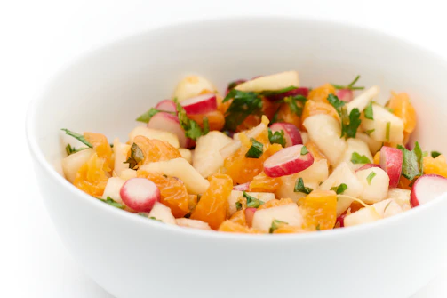 A colorful, fresh salad bowl with vibrant vegetables and herbs, perfect for a healthy diabetic-friendly meal.