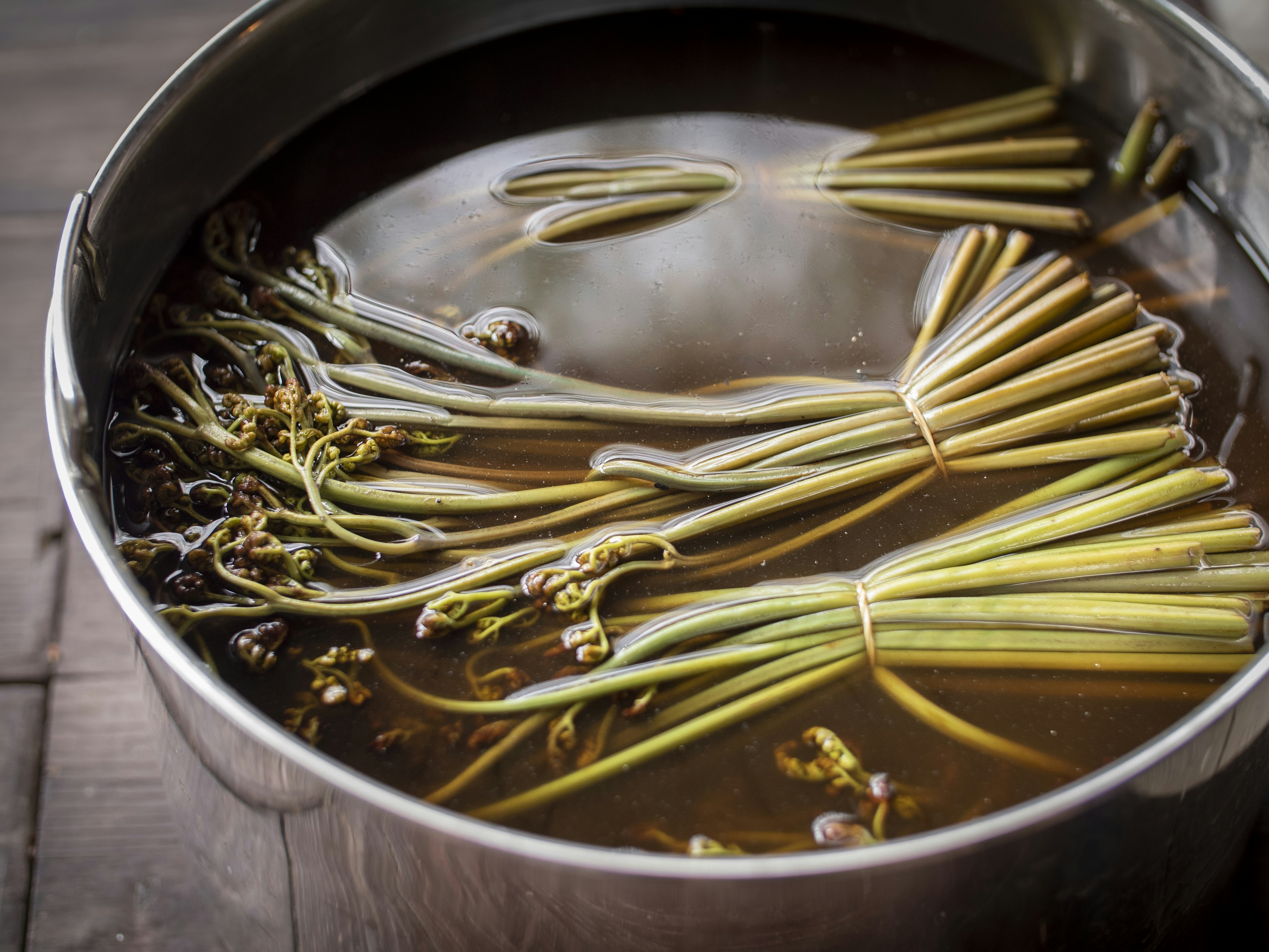 a pot filled with water and green beans