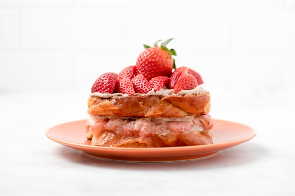 Strawberry and bread on white ceramic plate