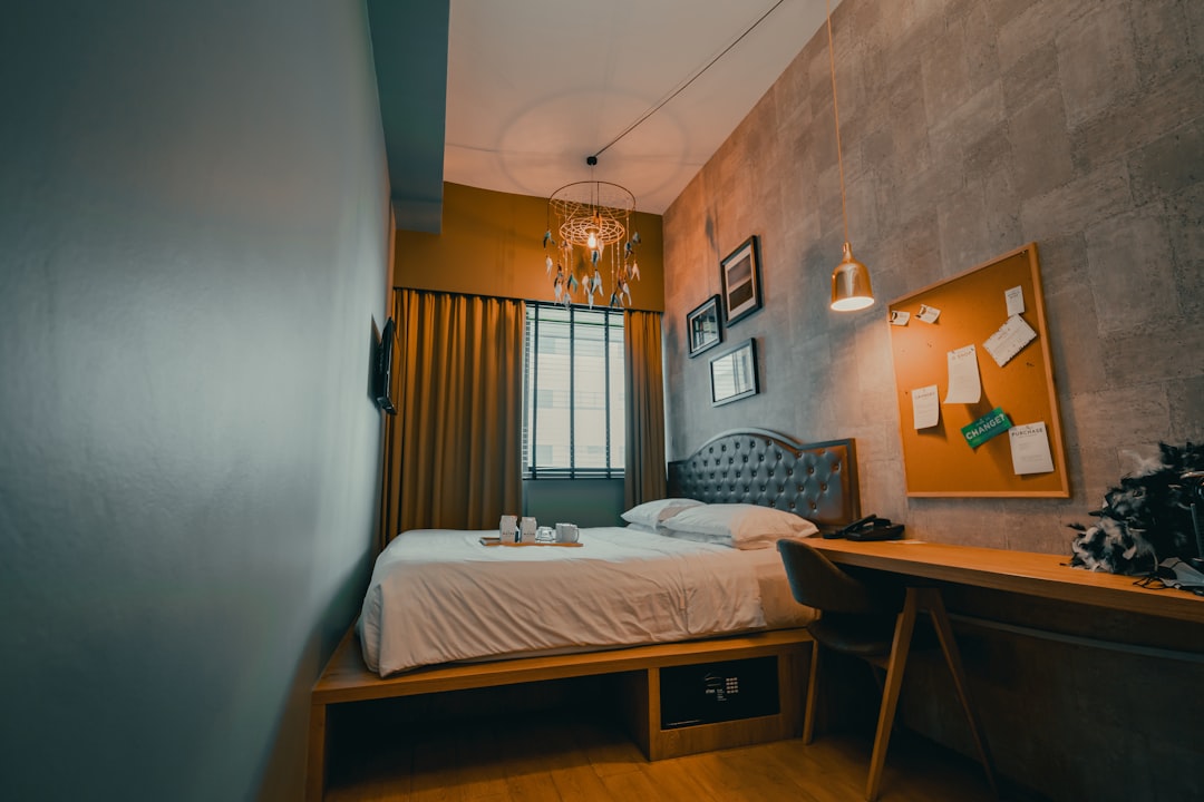 white bed linen on bed,