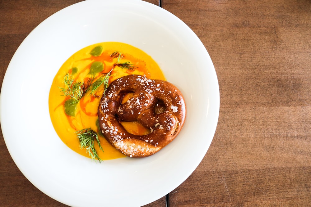 brown doughnut on white ceramic plate