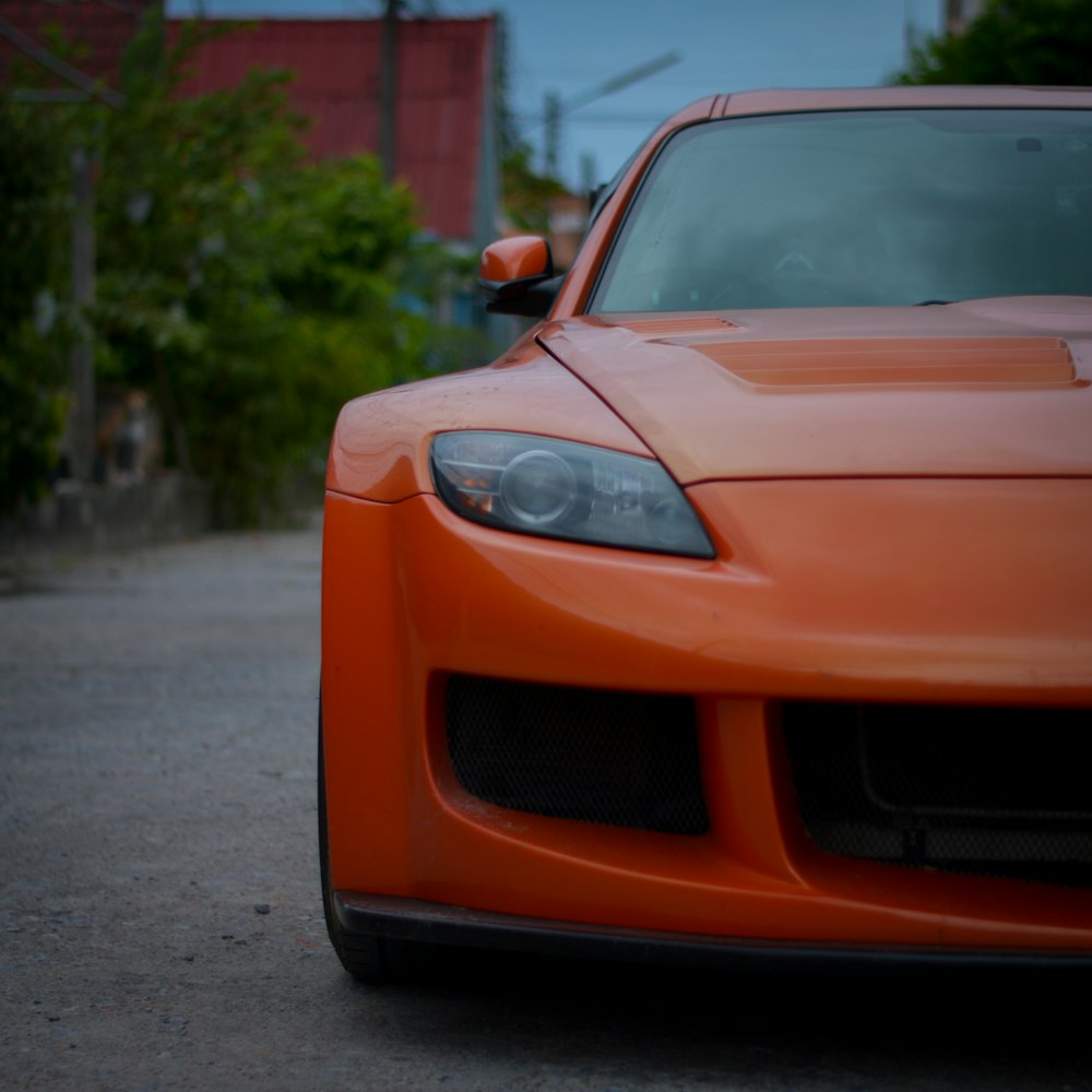 orange ferrari car on road during daytime