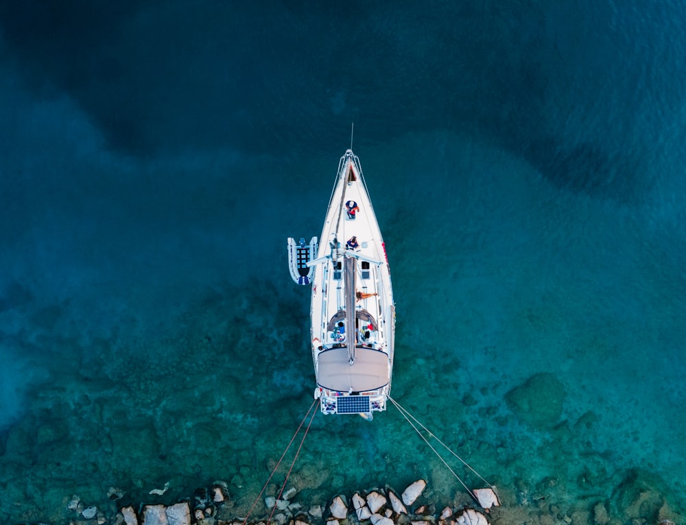 white and blue boat on sea during daytime