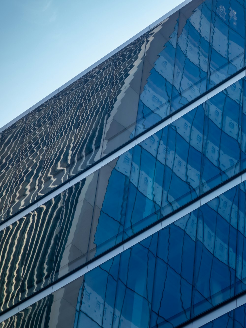 blue glass walled high rise building