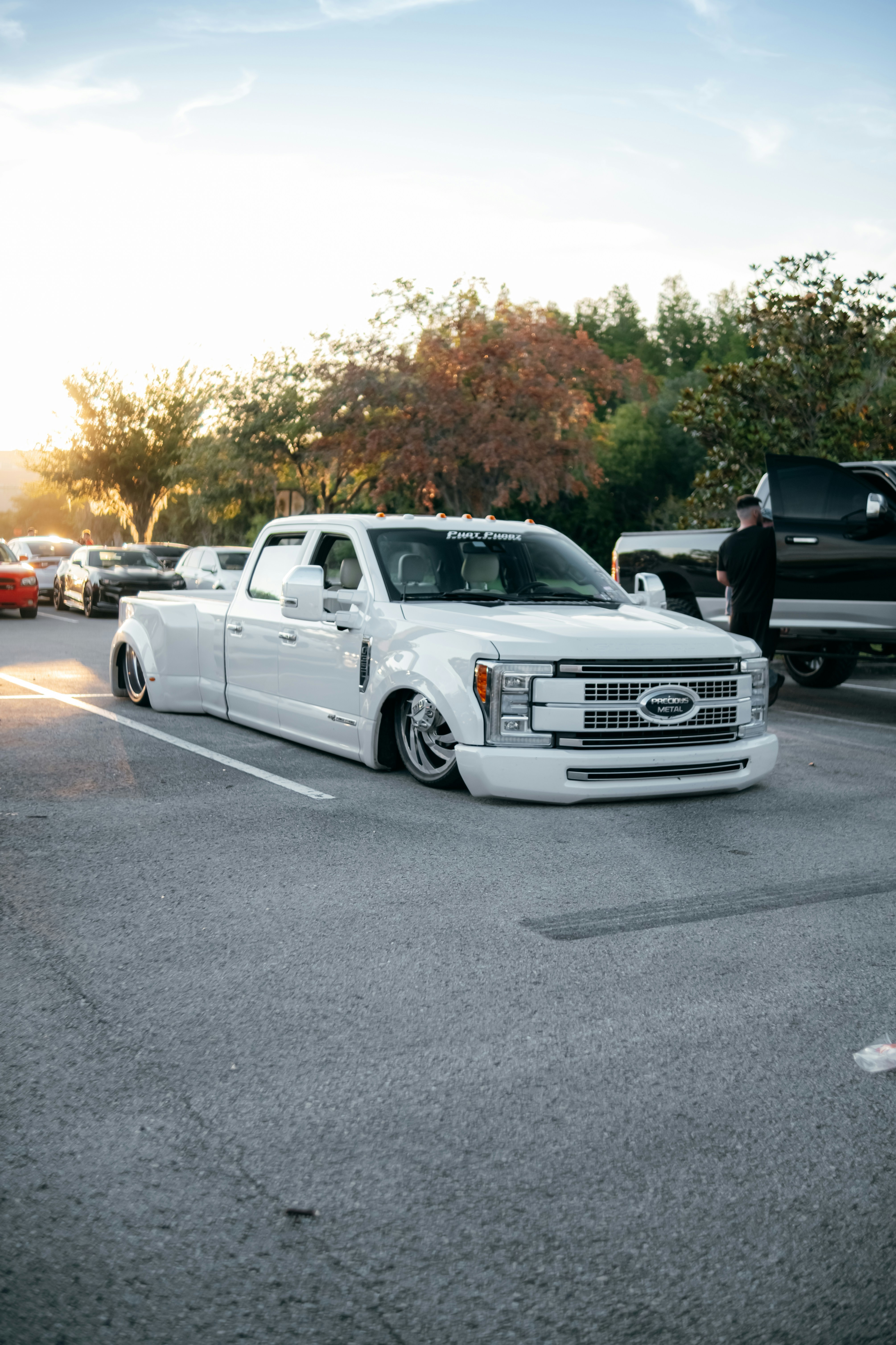 white chevrolet crew cab pickup truck on road during daytime