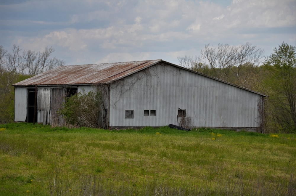 brown wooden house on green grass field during daytime