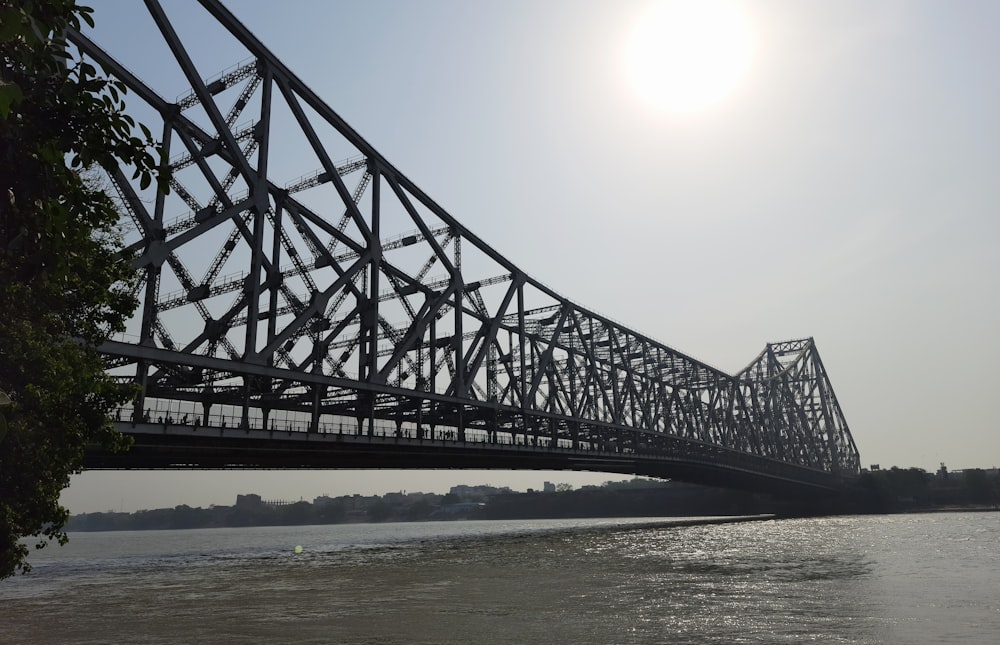 black metal bridge over the sea during daytime