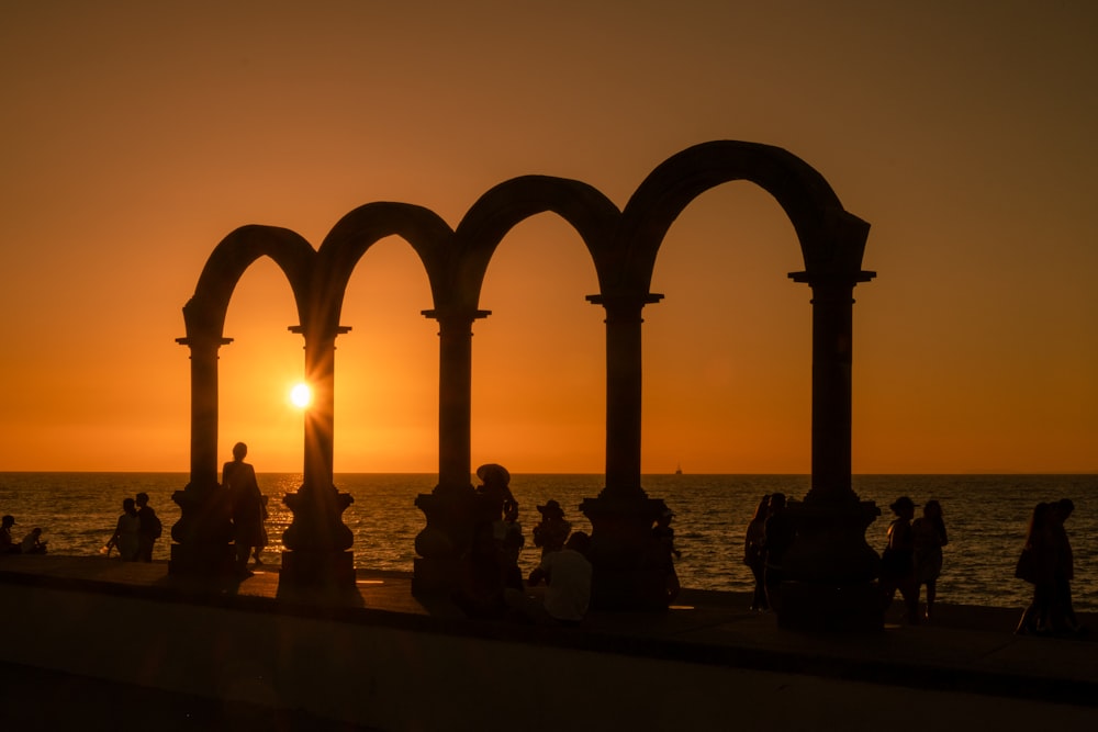 silhouette of people on beach during sunset