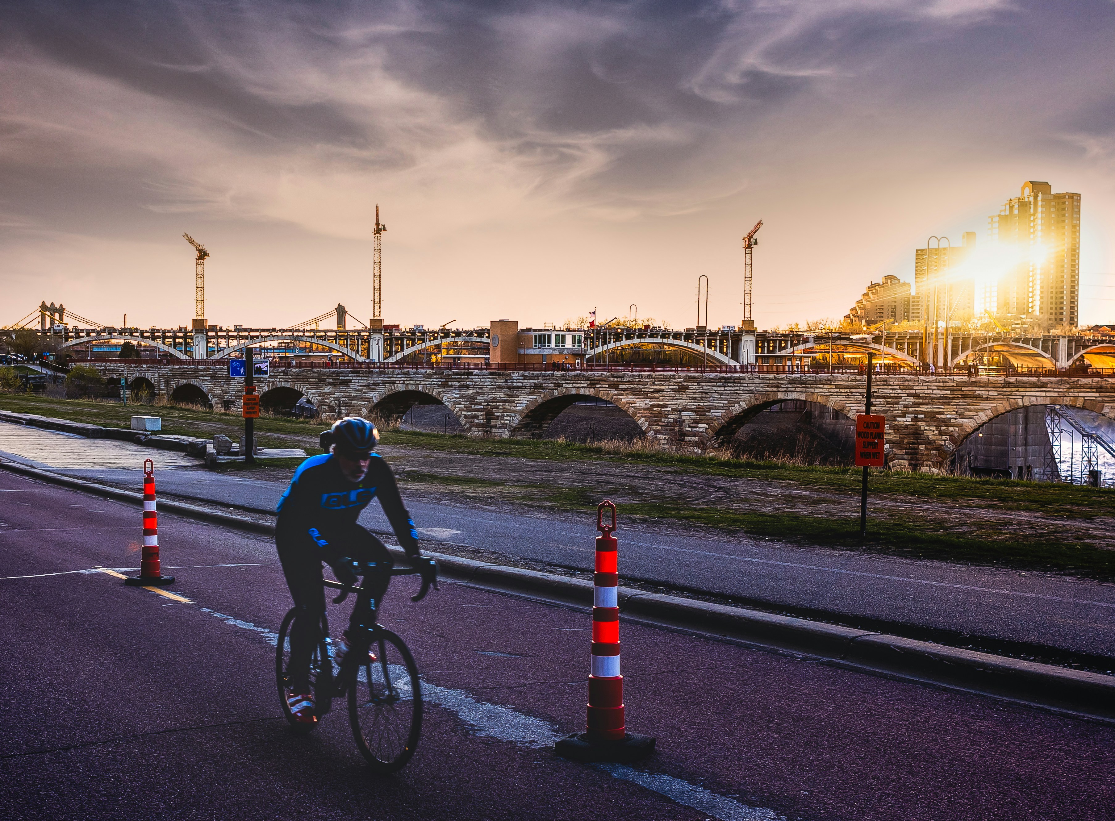 Person on a bycicle, Stone arch Bridge April 2021...