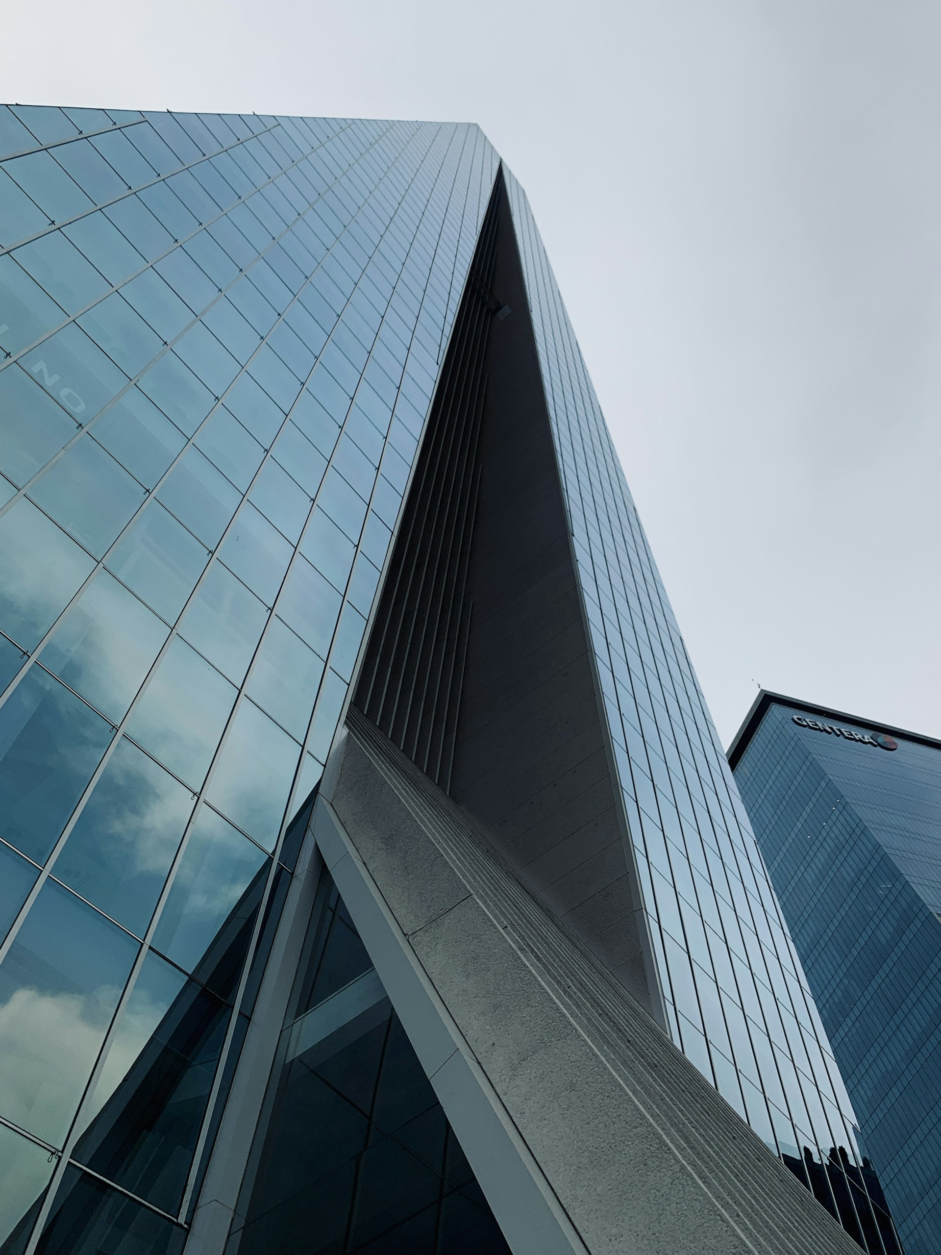 blue glass walled high rise building