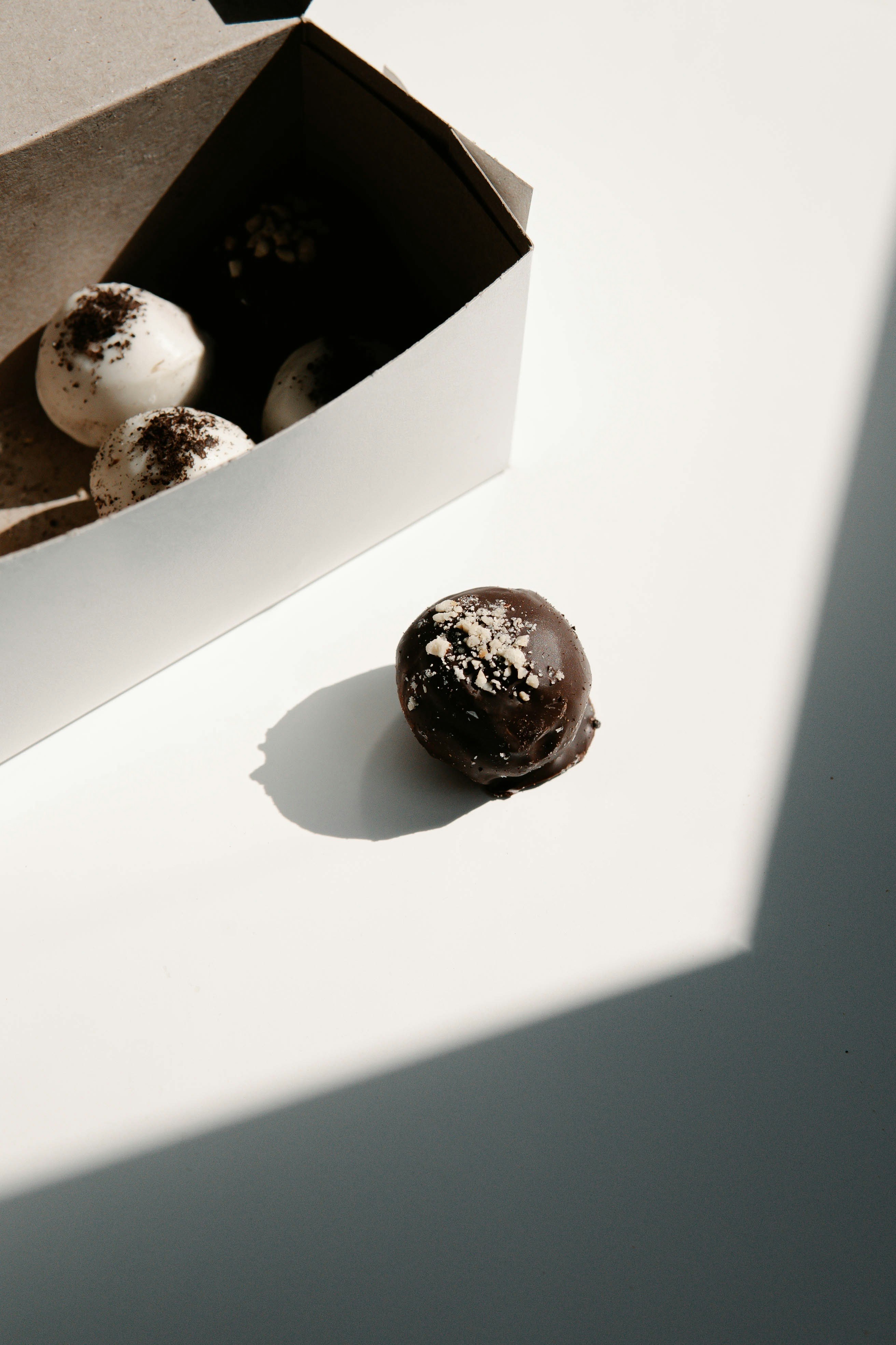 chocolate coated doughnuts on white box