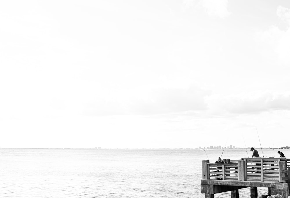 grayscale photo of house on sea