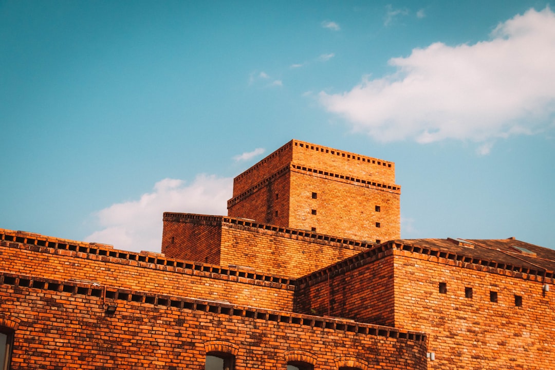 brown brick building under blue sky during daytime