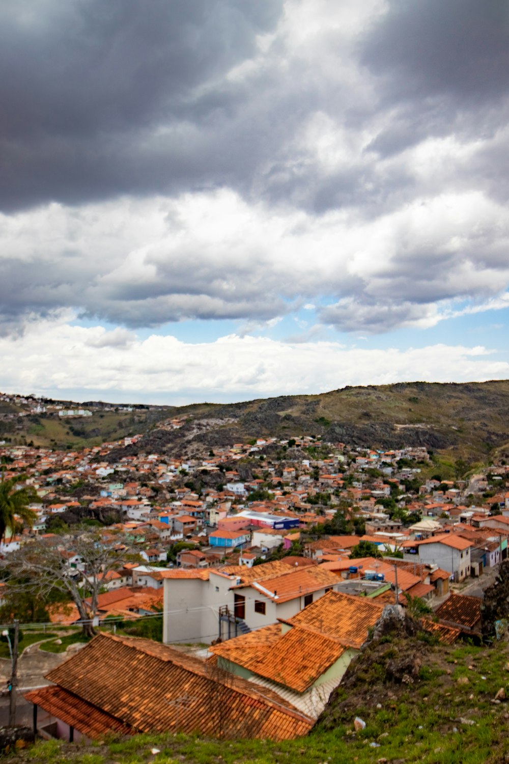 white and brown concrete houses on mountain under white clouds during daytime