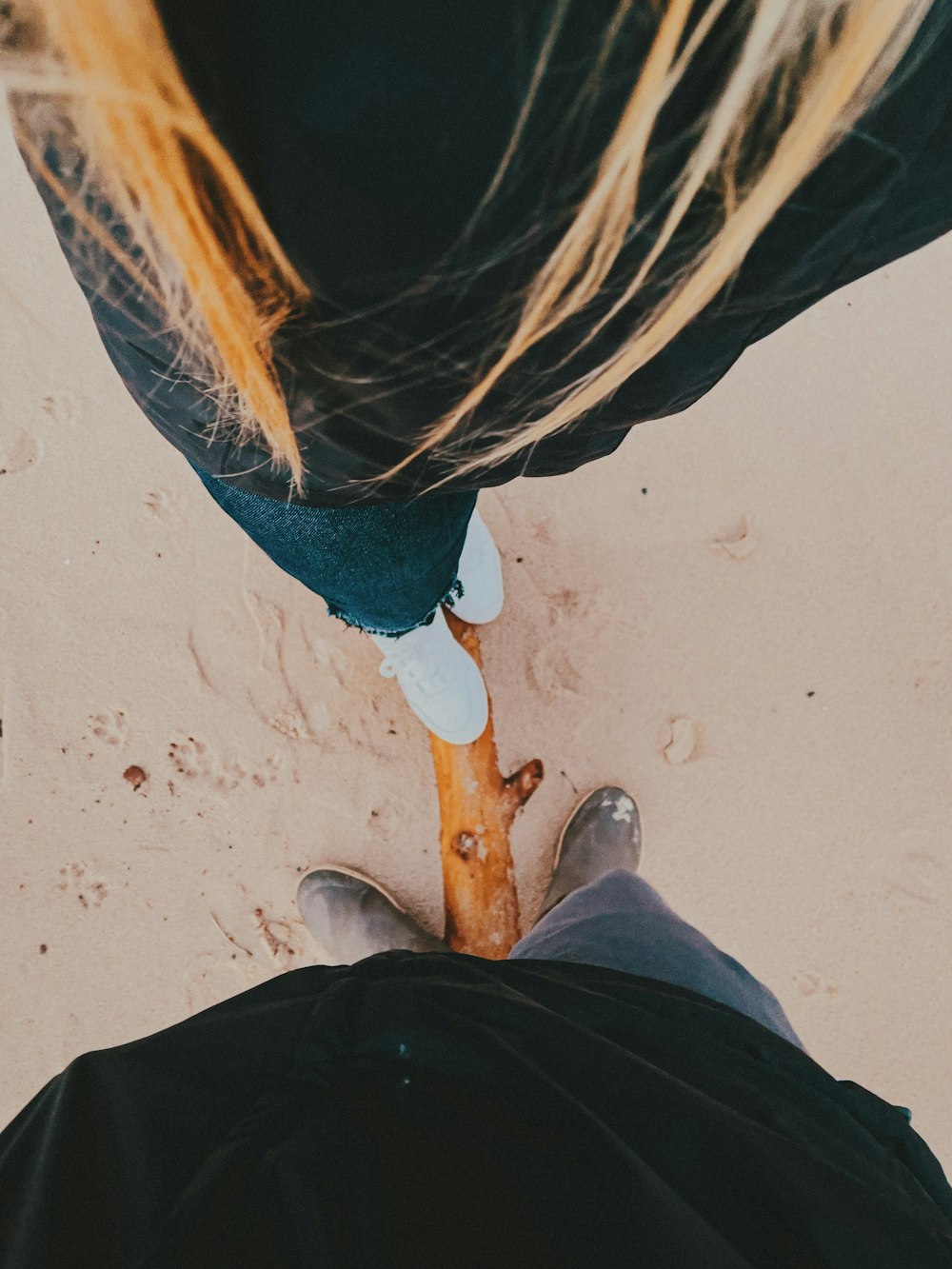 person in black pants and brown leather boots