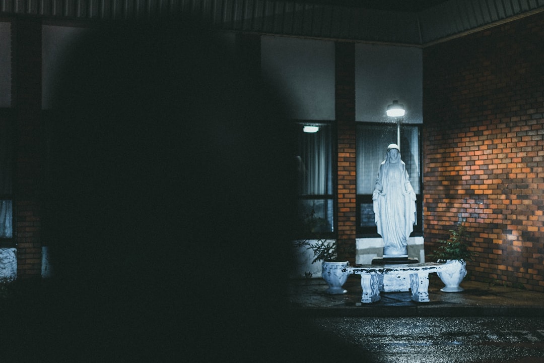 man in white robe standing on hallway