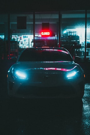 black car on road during night time