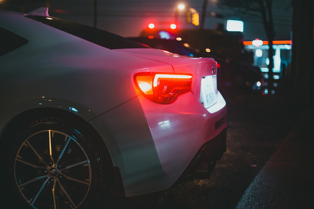 white car on the road during night time