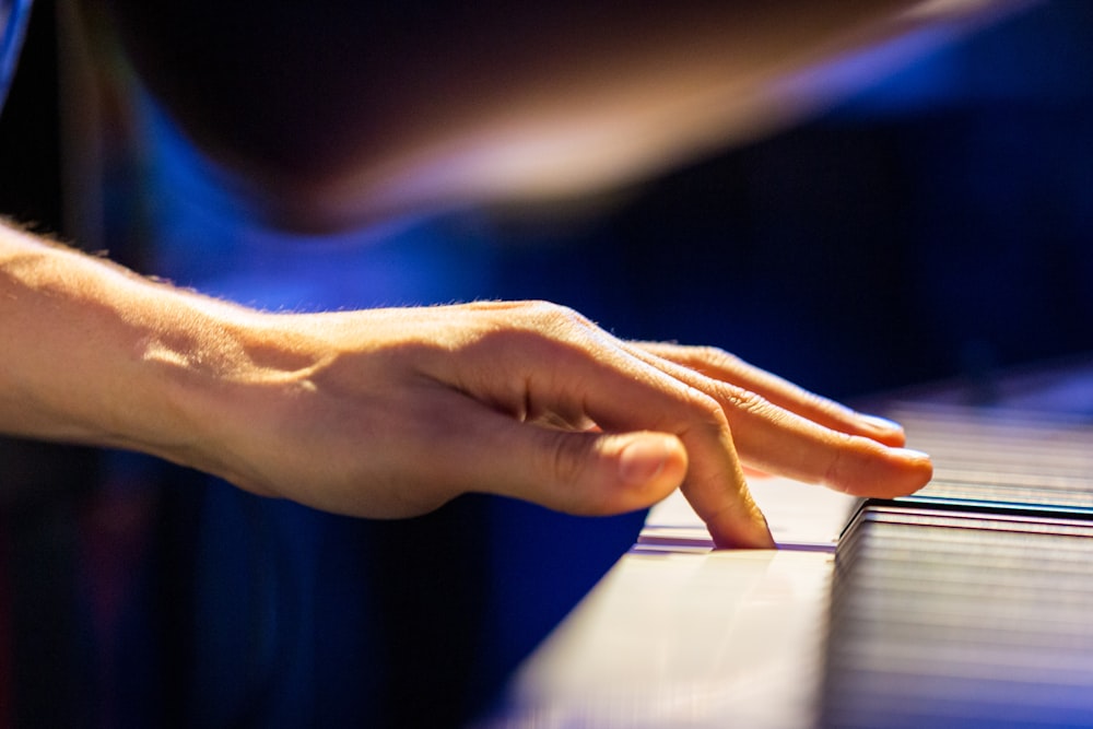 person playing piano in close up photography