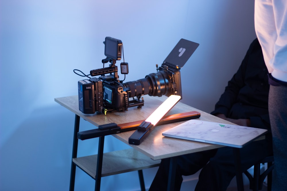 black and brown camera on brown wooden table