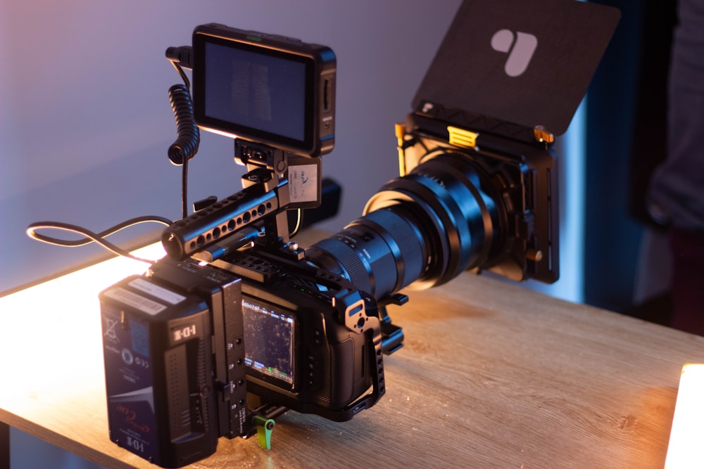 black dslr camera on brown wooden table