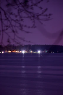 Night view of the flats illuminated softly against the natural backdrop.