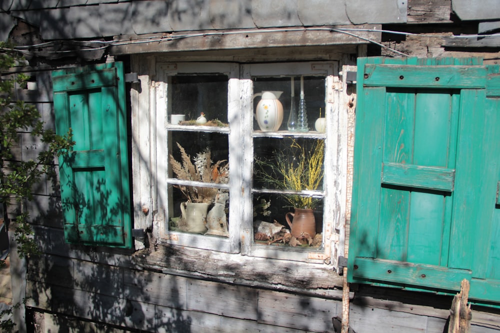 green wooden window with white wooden frame