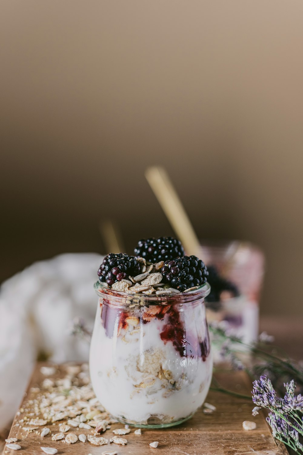 clear drinking glass with ice and black berries