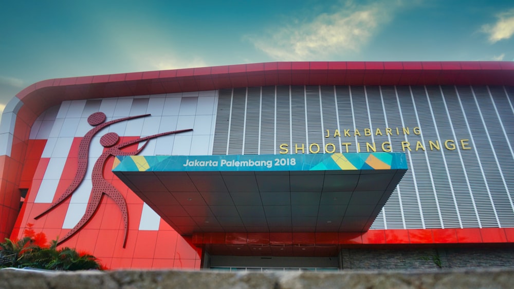 a red and white building with a sign on it