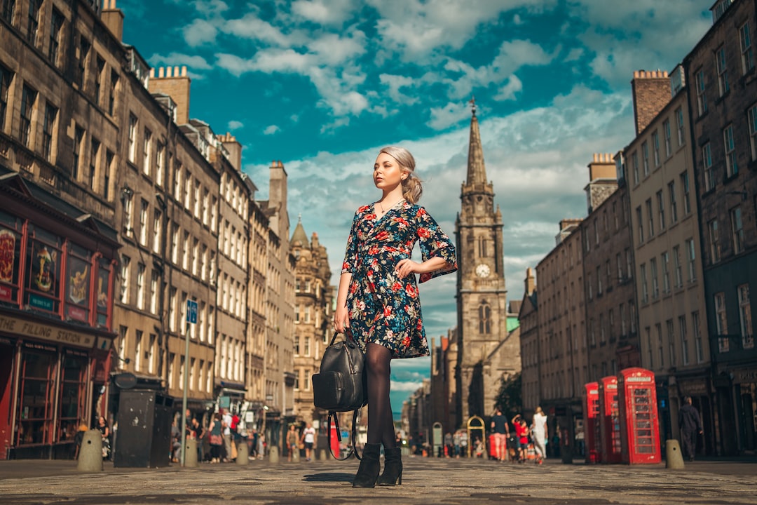 woman in black and red floral dress standing on the street