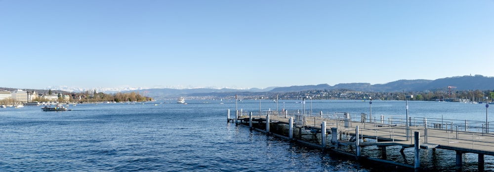 white and black wooden dock on sea during daytime