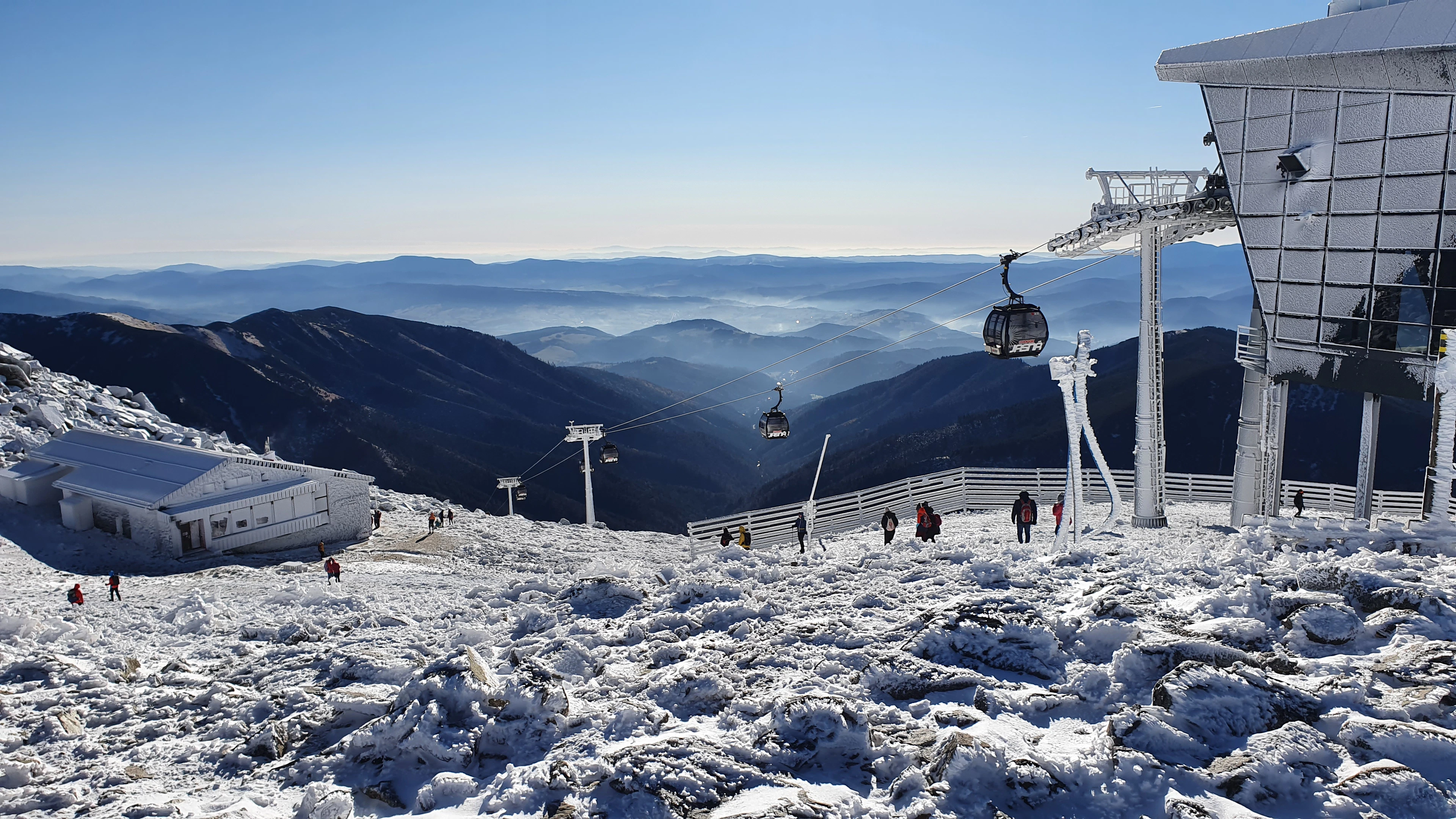 Skiers on the snowy summit of Chopok above the resort, skiing Jasná in Slovakia's Low Tatras