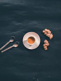 A close-up of golden ginger tea served in a delicate porcelain cup.