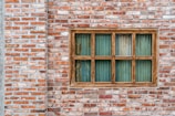 Rustic klinker window sill blending with brick facade.