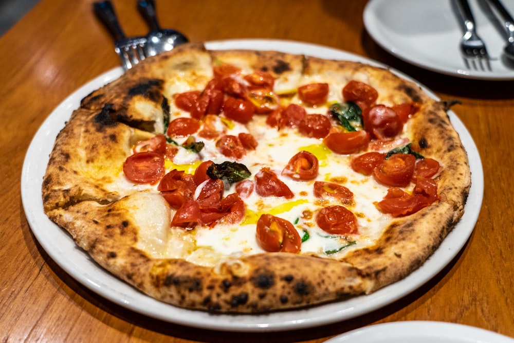 pizza with green and red bell pepper on white ceramic plate