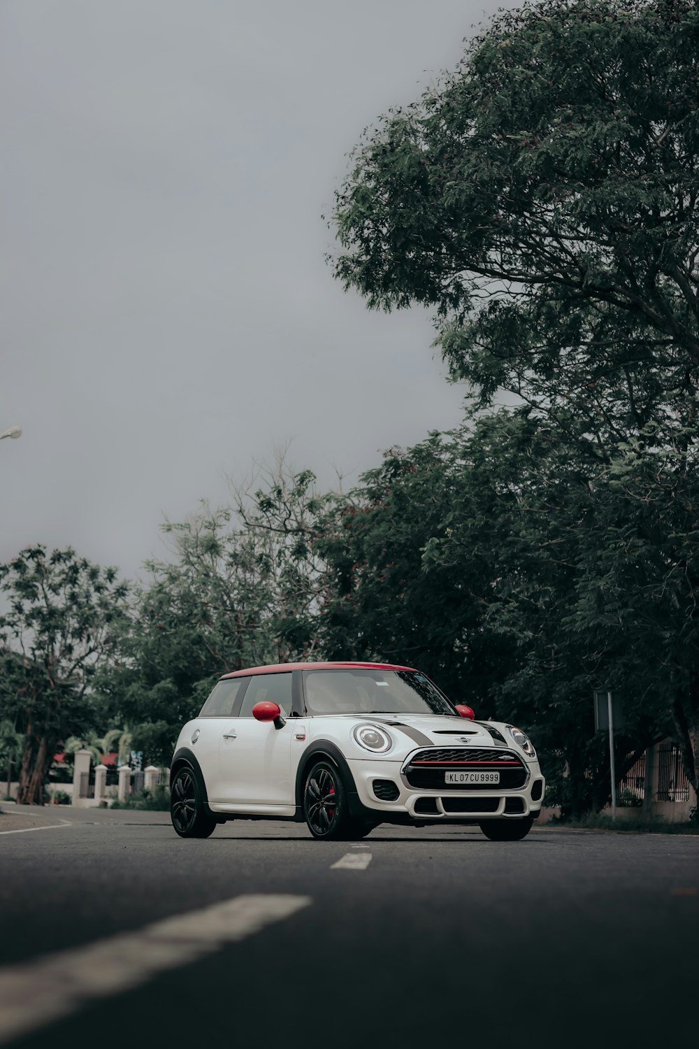 white and red porsche 911 on road near green trees during daytime