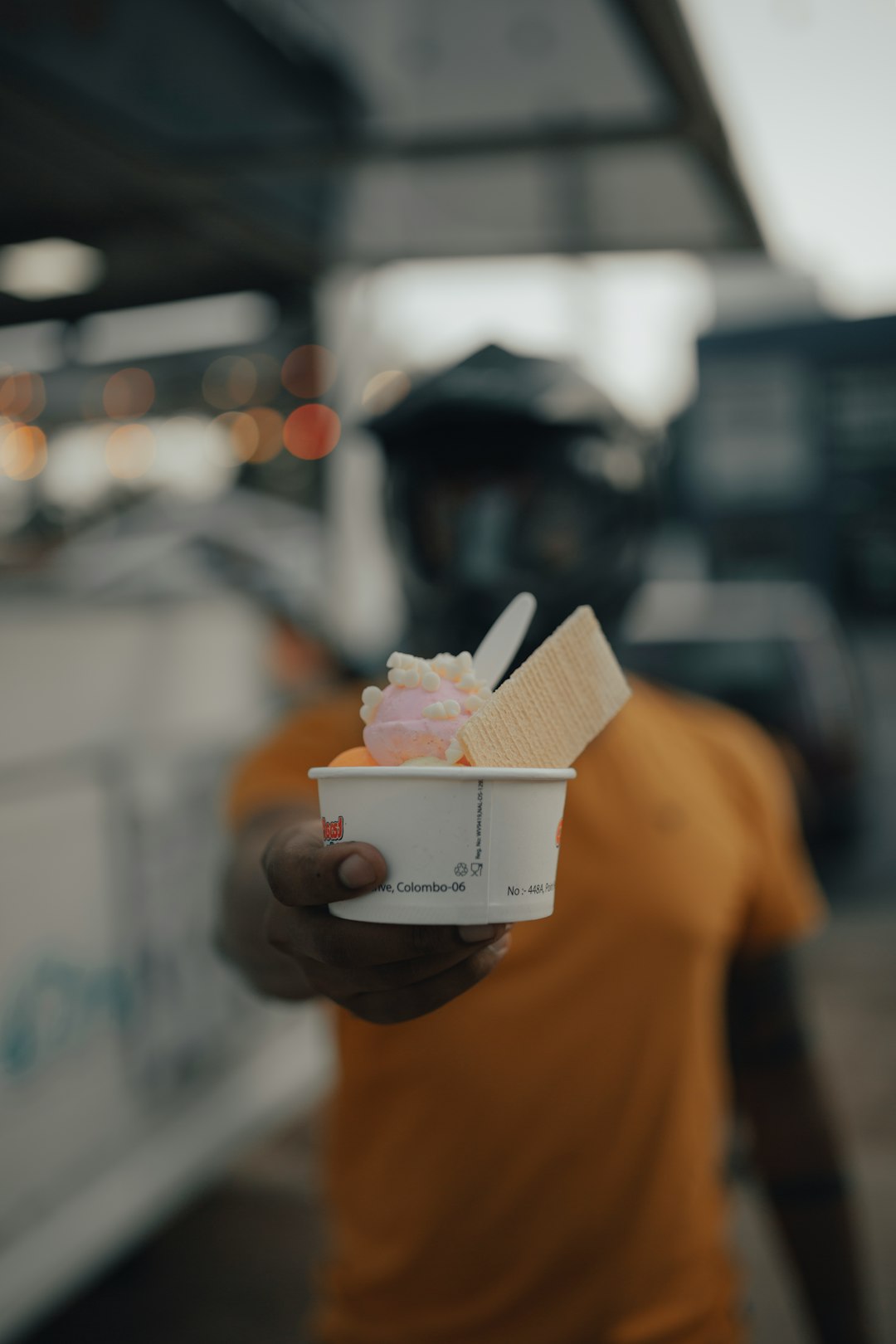 person holding white and pink plastic cup